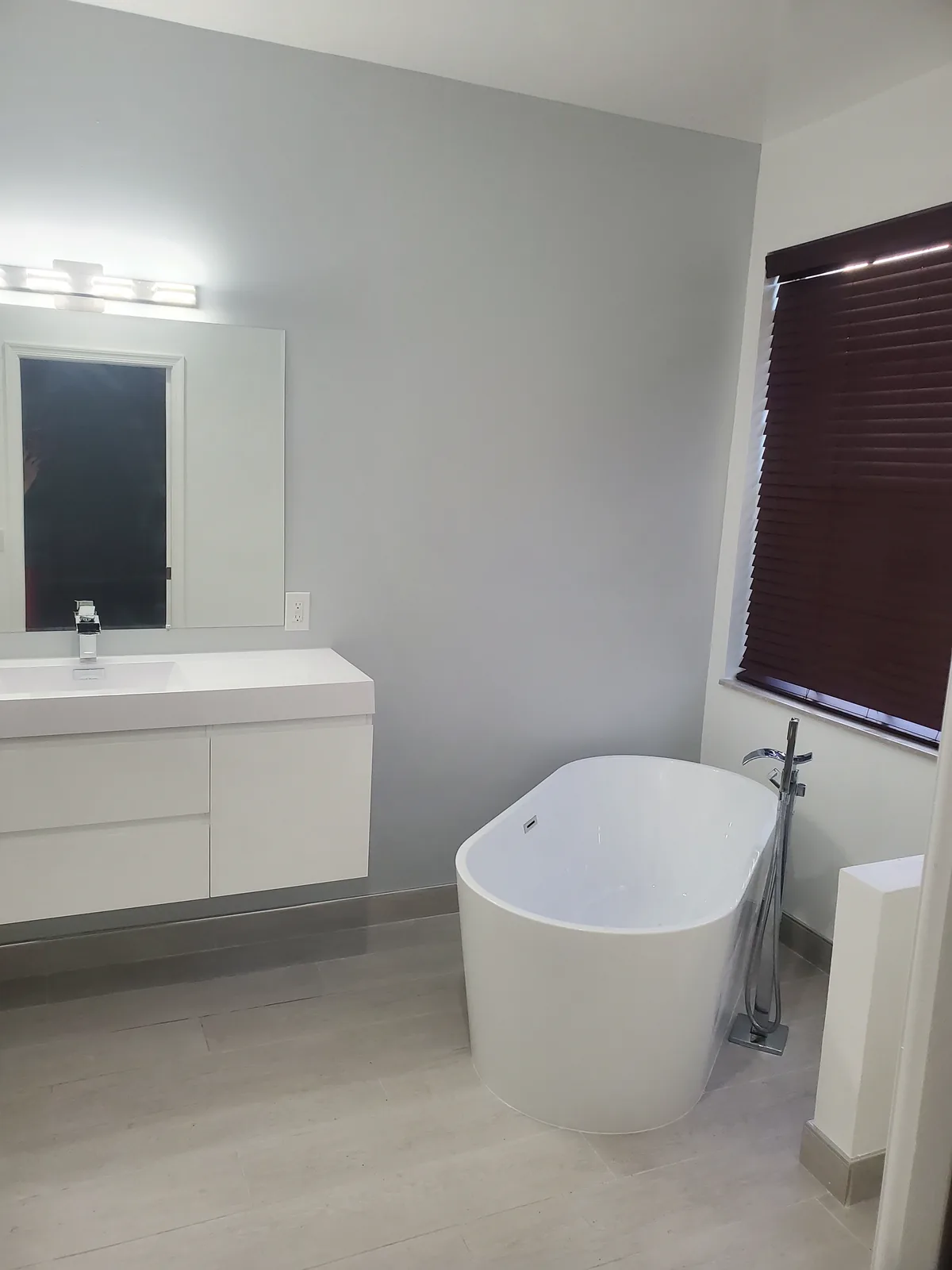 Custom home bathroom with freestanding soaking tub by Red Spade Repairs in South Florida