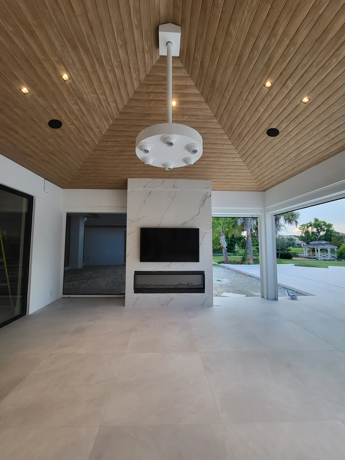Covered outdoor living patio with feature wall by Red Spade Repairs in South Florida